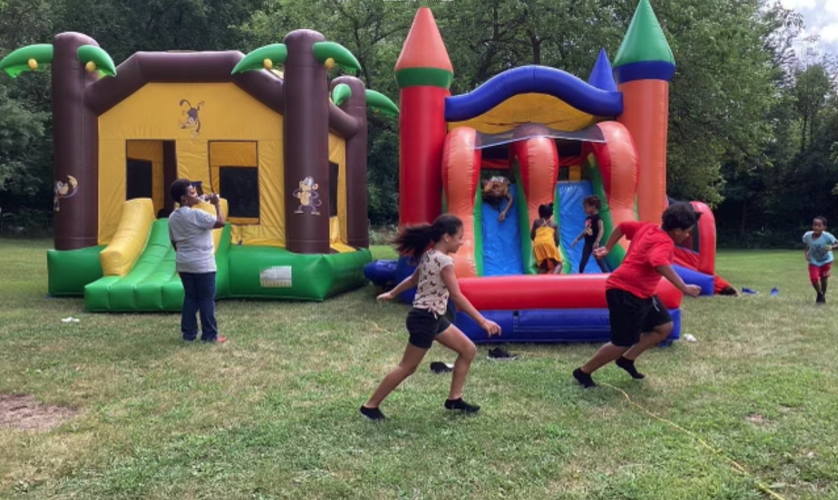 Forward-for-Fun-grant-Book-Bag Give-away-Searls-2024-kids playing around bouncey houses